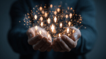 Man holds glowing team leaders with crown symbolizing success and leadership in business strategy