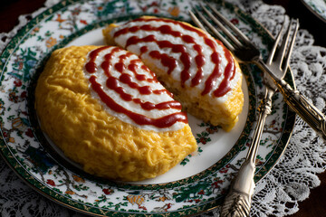 Delicious omurice with fluffy eggs and artistic ketchup design on decorative plate