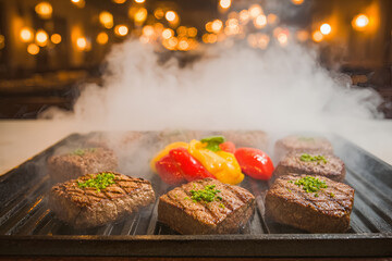 Sizzling Japanese wagyu steak on teppanyaki grill with colorful peppers creates delightful scene
