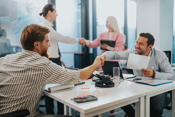 Two teams seal a deal during a friendly business meeting in a modern office today