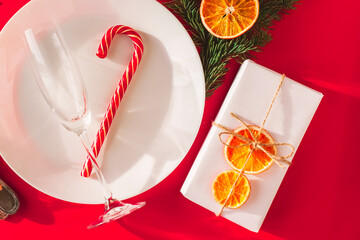Christmas table setting for christmas dinner, served table with plate, gift, champagne glass, New...