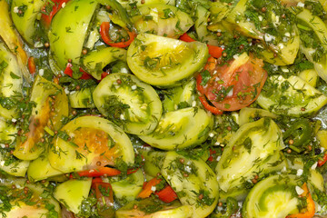 Salad of sliced pickled green tomatoes.