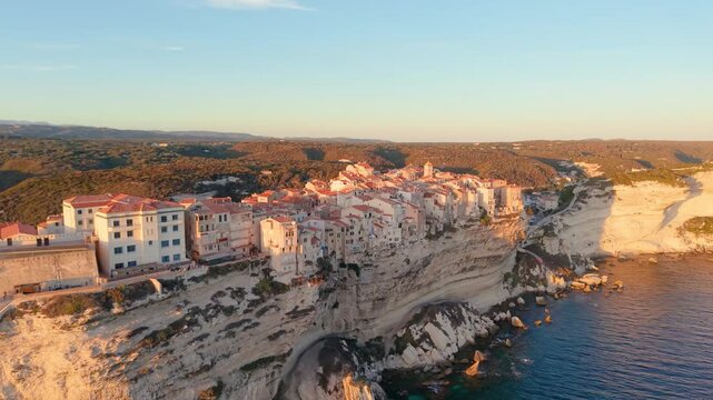 Aerial view of coastal sunset City, peaceful mediterranean coastal community with terracotta roofs during sunset. Bonifacio. France