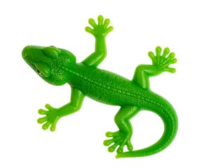 Fototapeta premium Bright green plastic lizard with a textured back crawling on a white surface
