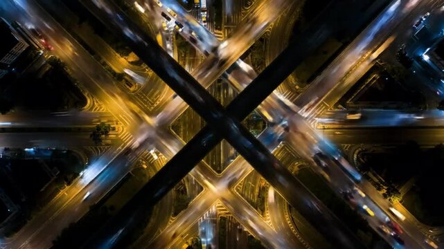 Aerial view of city intersection illuminated at night with traffic  