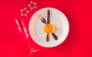 Christmas table setting for christmas dinner, served table with plate, gift, champagne glass, New year decorations. Flat lay, top view