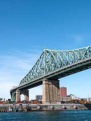 Jacques-Cartier bridge linking Longueuil and Montreal, Quebec, Canada on a sunny autumn morning taken from the Saint-Lawrence river