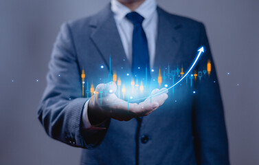 Businessman holding a glowing rising graph with candlestick chart, symbolizing financial growth, investment success, and stock market analysis in digital business concept.