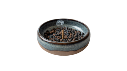 Serene incense stick smoldering emitting delicate wisps of smoke in a rustic ceramic bowl filled with aromatic beads promoting calm and tranquility isolated on white or transparent png.