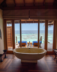 Tranquil closeup calm sea water waves with palm trees. Beautiful Panorama, Tropical island beach landscape exotic shore coast. Summer vacation, holiday amazing nature. Relax paradise, Maldives.