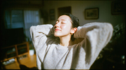 Smiling woman enjoying fresh morning sunlight with relaxed and positive mood