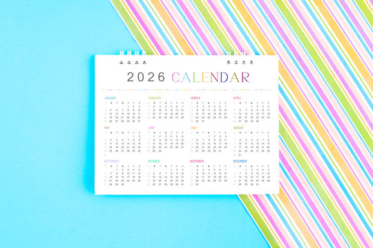 2026 desk calendar on colorful background.