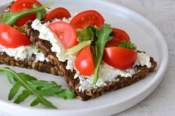 Nutritious wholegrain bread Sandwiches with Cottage Cheese, Tomato and Arugula close up