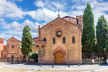 Stunning brick architecture of S. Stefano Basilica in Piazza Santo Stefano, Bologna. The serene square offers a peaceful retreat surrounded by trees and historical charm.