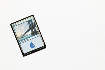 Obraz premium Bradford, UK Nov 3 2025 Basic Land Island Spider-man card magic the gathering card shot isolated on a white paper background.