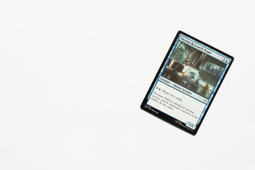 Obraz premium Bradford, UK Nov 3 2025 Oscorp Research Team card from the Spider-man magic the gathering card game shot isolated on a white paper background.