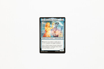 Obraz premium Bradford, UK Nov 3 2025 Lyla, Holographic Assistant card from the Spider-man magic the gathering card shot isolated on a white paper background.