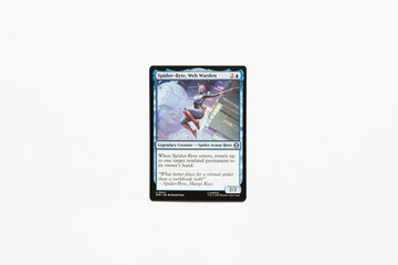 Obraz premium Bradford, UK Nov 3 2025 Spider-Byte, Web Warden card from Spider-man magic the gathering card game shot isolated on a white paper background.