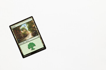 Naklejka premium Bradford, UK Nov 3 2025 Forest basic land card from Spider-man magic the gathering game shot isolated on a white paper background.