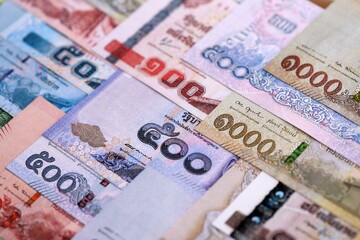 Obraz premium Thai Baht currency money bills. THB currency banknotes in pile with different denomination close up