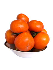Plate is filled with persimmons, Delicious persimmon fruits on a white plate, Fresh ripe sweet persimmons