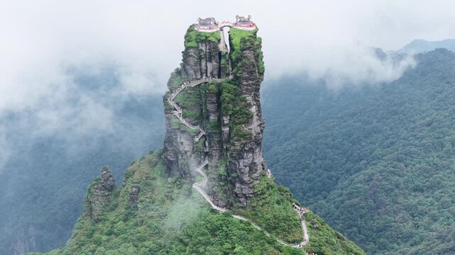 Aerial view of the majestic Fanjingshan mountain, a UNESCO World Heritage Site, with its winding staircase and temples at the summit, Fanjingshan, Guizhou, China.