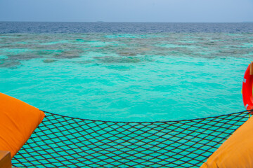 Tranquil closeup calm sea water waves with palm trees. Beautiful Panorama, Tropical island beach landscape exotic shore coast. Summer vacation, holiday amazing nature. Relax paradise, Maldives.