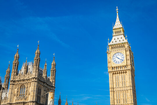 Big Ben tower seen from the south bank of the Thames river on a clear day in London, UK