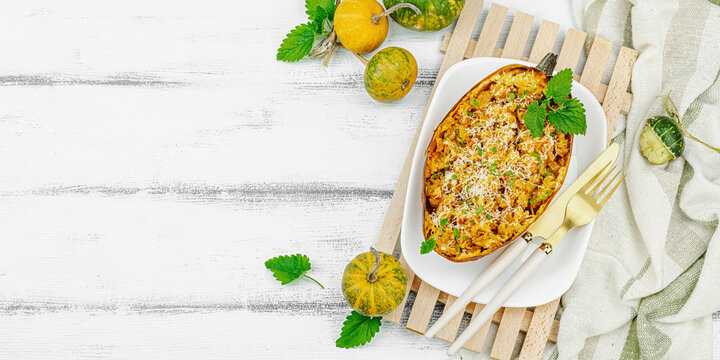 Baked spaghetti squash with spices, herbs and tomato sauce. Gluten free food, healthy dinner, vegan