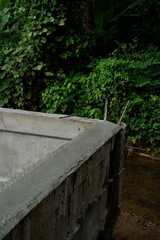 Reinforcement Steel Rebar Cage and Concrete Wall Foundation during Construction. Structural Engineering Detail.