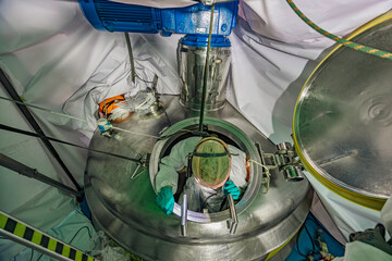 Male into work inspection process chemical into stainless steel tank confined.