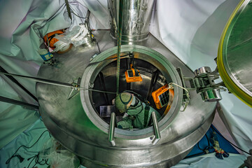 Male into work inspection process chemical into stainless steel tank confined.