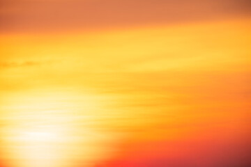 Vibrant, abstract gradient background featuring warm tones of orange, yellow, and a hint of purple, with a soft, natural bokeh effect, ideal for backgrounds or overlays.