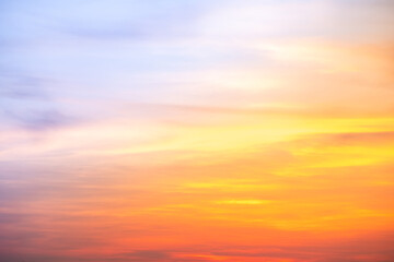 Sunset or sunrise sky with a vibrant gradient of orange, gold, and soft blue. Clear atmosphere with wispy clouds. Peaceful, natural light background. hope, freedom, new day and inspirational Concepts