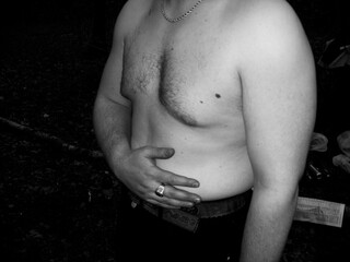 Handsome young man with naked torso in black and white.