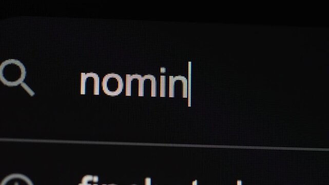 A close-up view of the company name "nominal" being typed into a search bar