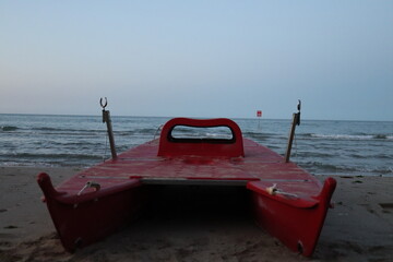 Small red rescue lifeboat on the sea, Italy