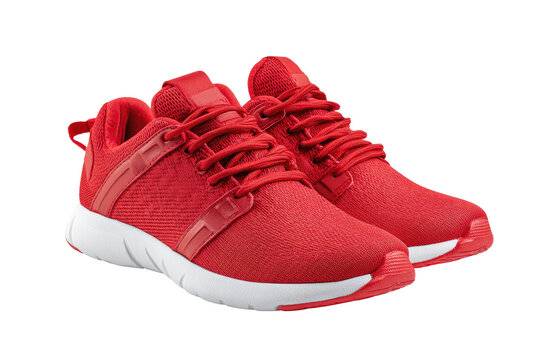 Pair of bright red athletic shoes. Close-up view of the shoes, lace-up style with a red laces, mesh upper, and white sole