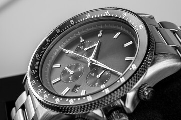 Modern men’s wristwatch with black dial, gray stainless steel bracelet and elegant timeless design