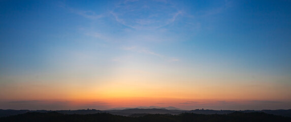 Panorama view of sunrise over the mountain with beautiful blue sky.