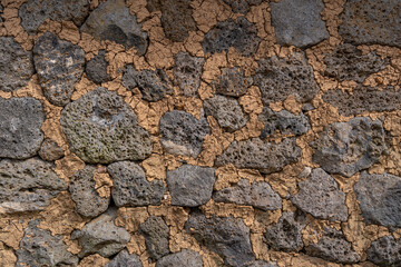 Naklejka premium A timeworn stone wall, where lava meets earth