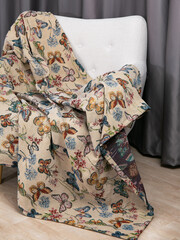 sofa cushions and bedspreads made of tapestry on a sofa or armchair, variegated fabric