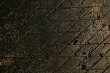 concrete textured surface with a repeating diamond-shaped, wet