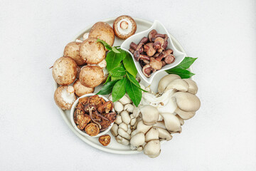 Assortment of various mushrooms - fresh, dried and pickled. Oyster, cremini, porcini and shiitake