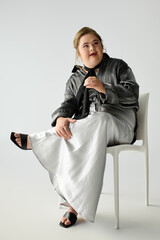 Young woman radiates joy while posing stylishly in a modern studio setting