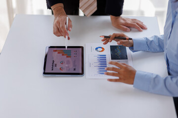 Meeting of business executives discussing analysis of the company's financial situation and business planning with partner collaboration and consultation of strategy.

