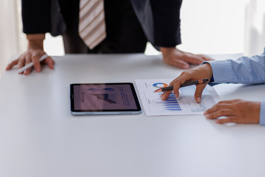 Meeting of business executives discussing analysis of the company's financial situation and business planning with partner collaboration and consultation of strategy.


