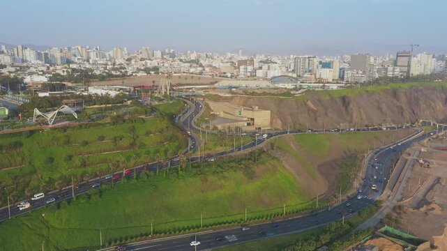 Aerial footage capturing daily traffic on a highway in miraflores, lima with the city in the background
