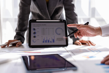 Financial Analysis. Business team woman calculating data with calculator and laptop in modern office.