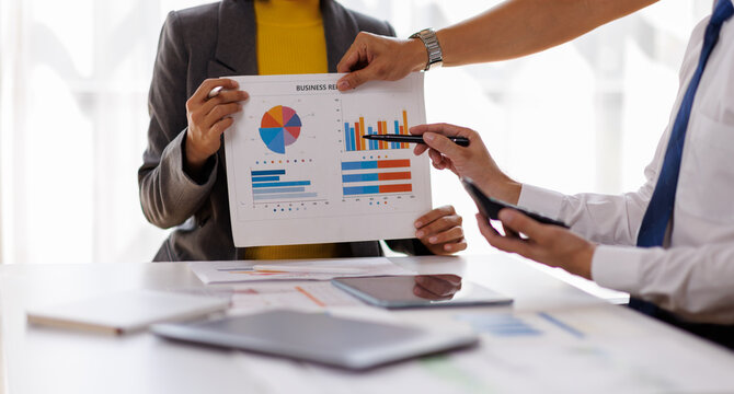 Asian business adviser meeting to analyze and discuss the situation on the financial report in the meeting room.Investment Consultant, Financial advisor and accounting concept

